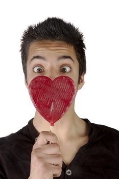Pakistani teenage boy is looking surprised at a lolly heart