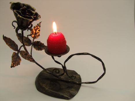 metallic candle with a rose and a candle