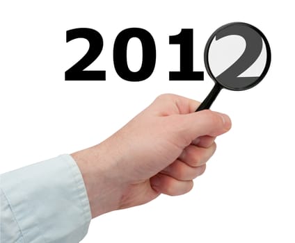 New Year - Man's Hand Holding Magnifying Glass Over 2012 Sign