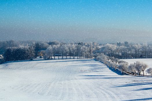 winter scene with snow, sun and blue sky