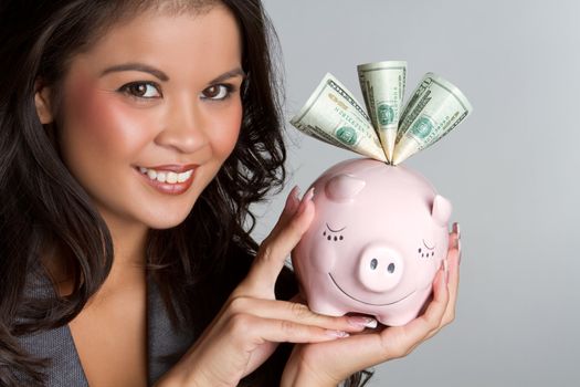 Smiling woman holding piggy bank