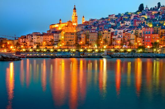 Menton Provence village at night with water reflection