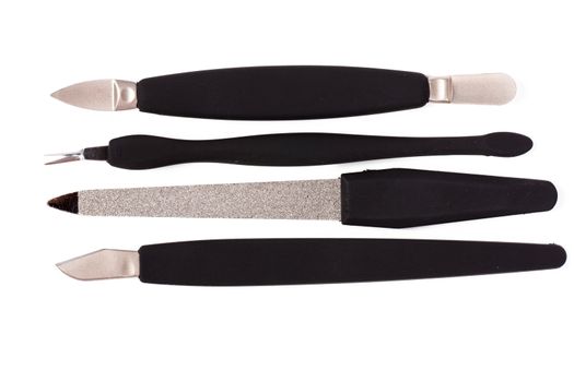 A set of metallic with black handles manicure tools.