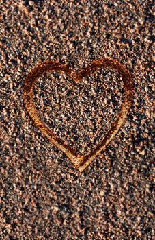 Heart contour on pebbles background.