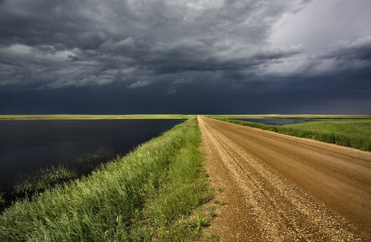 Storm Clouds over Prairie slough and road