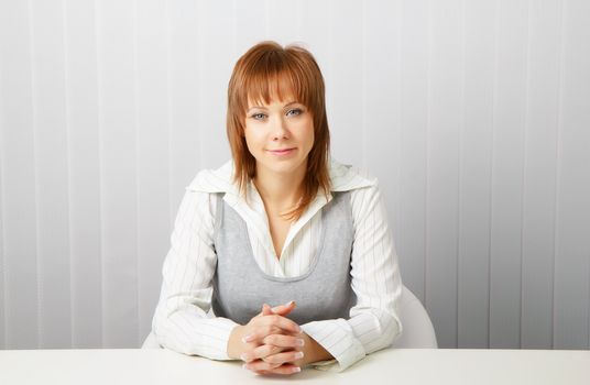 blue-eyed happy attractive young businesswoman in office