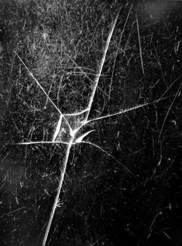 Cracked glass of cell phone display screen, vertical view