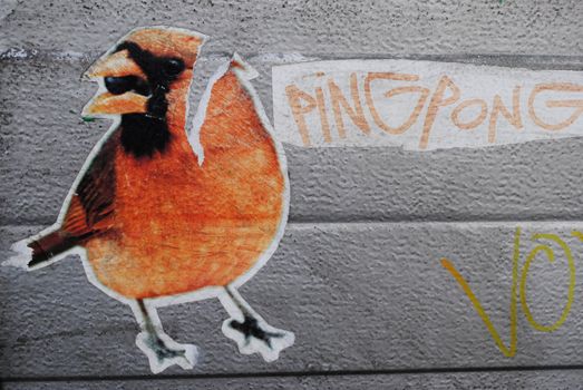 A street art sticker of a bird.