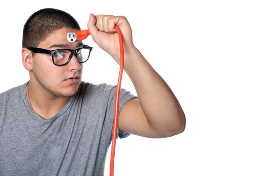 Conceptual image of a young man holding an electrical chord disconnected from the outlet on his forehead.