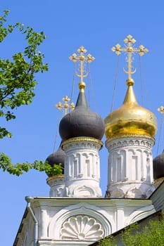 Domes of  orthodox church against  blue sky, Russia.