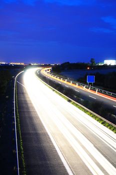 night time traffic on highway with lights showing transportation concept
