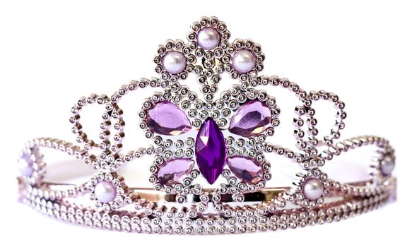 Silver color tiara with purple and lilac stones and pearls isolated on white background