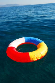 swim ring floating on beautiful blue lake