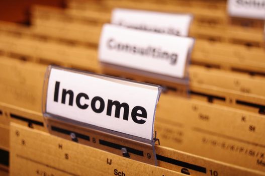 income word on business folder showing finance financial or earnings concept