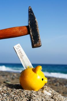 closev up of yellow piggybank with hammer