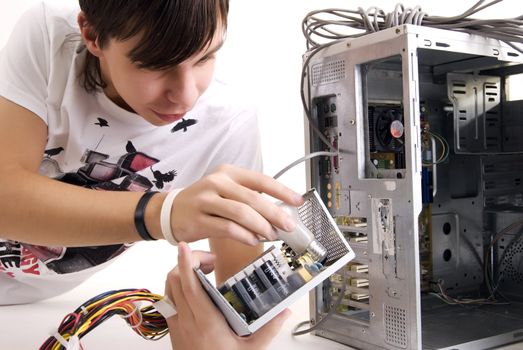 young man repairing his computer