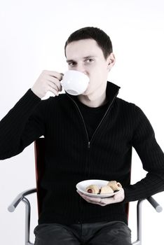  young man drinking tea with cookies