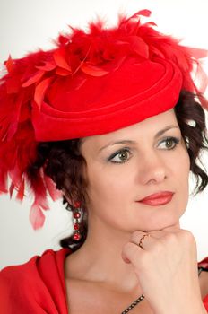 Portrait of the woman in a red hat with feathers