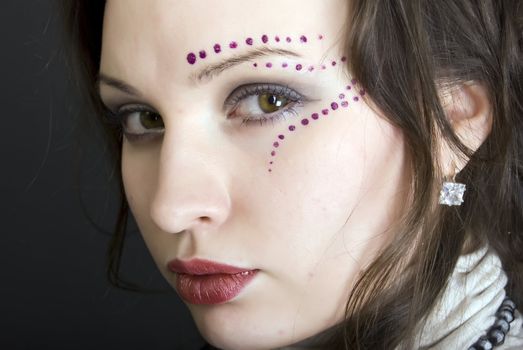 Portrait of a young beautiful brunette with eastern make-up