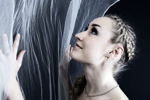  Young beautiful bride posing over black