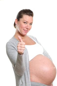 pregnant woman showing thumbs up and smiles

