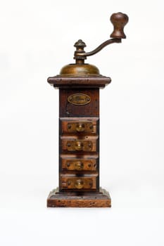 OLD WOODEN PEPPER MILL ON WHITE