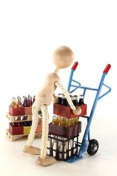 doll loads sack truck with cola, lemonade, milk and beverages stacked on euro pallets in the background