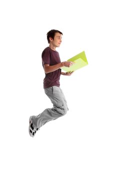 A casual dressed teenage student mid jump.  He is holding a folder and smiling.  Some motion in shoes