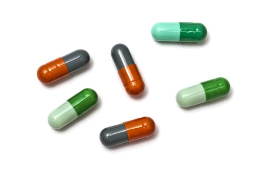 A few colorful capsules isolated on white background 
