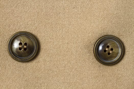 Two big buttons fixed on fabric background