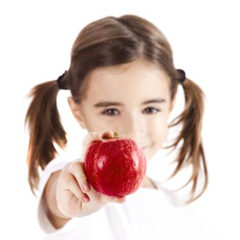 Healthy little girl holding and showing a red apple
