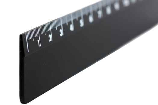 Black plastic ruler isolated over white