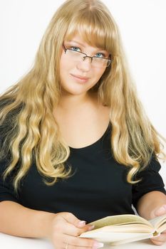 girl with long hair sitting at the table reading