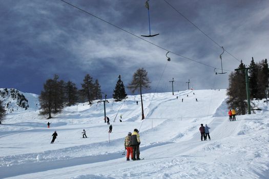 People skiing by beautiful weather in Alps mountain, Switzerland