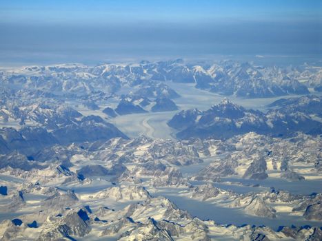 Aerial view of glaciers surrounded by peaks in Greenland
