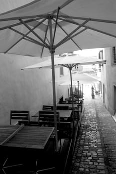 Classic Swiss alley with tables and chairs.