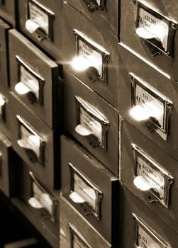 An office drawer in a library with a number of file boxes 