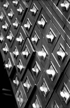 An office drawer in a library with a number of file boxes 