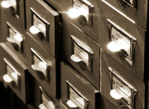 An office drawer in a library with a number of file boxes 