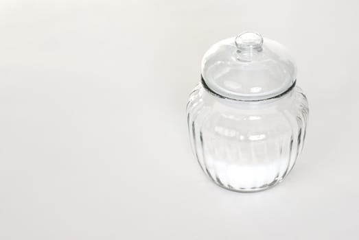 A jar of sugar on a white background.
