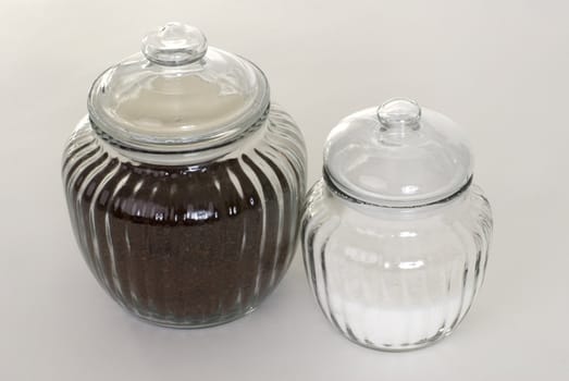 A jar of coffee and sugar on a white background.