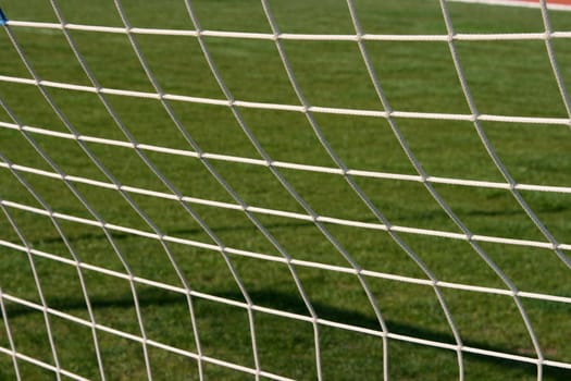 goalpost net detail with green grass blur in background sports concepts
