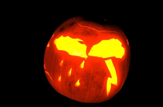 Stormy weather patterns carved onto a jack-o-lantern halloween pumpkin.  Isolated on #000000.