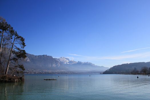 Annecy lake panorama with the Alps mountains by beautiful winter weather