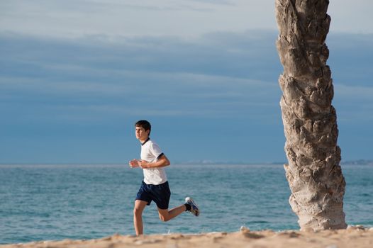 Teeager jogging on the beach early morning