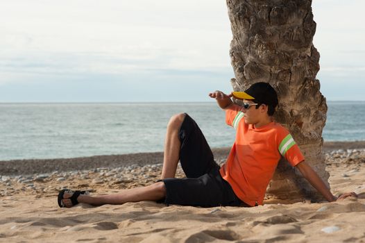 Teenager on the beach watching out for the things to come