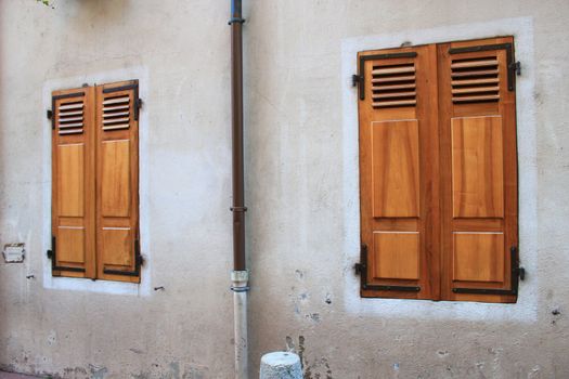 Two wooden shutters closed on a wall at Annecy old city, France