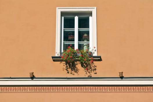 Detail of an old window with colorful flowers.