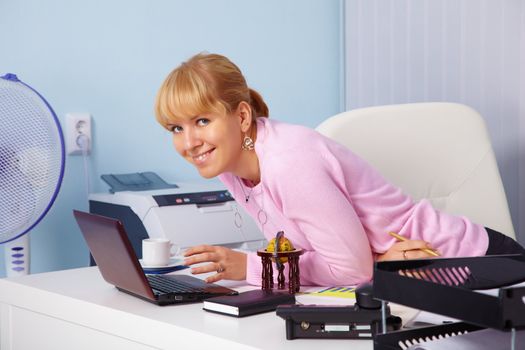 A beautiful smiling young girl in a bright office
