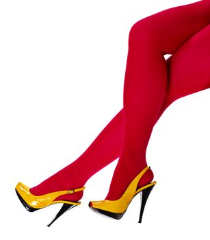 Beautiful women's feet in the yellow shoes and a crimson tights